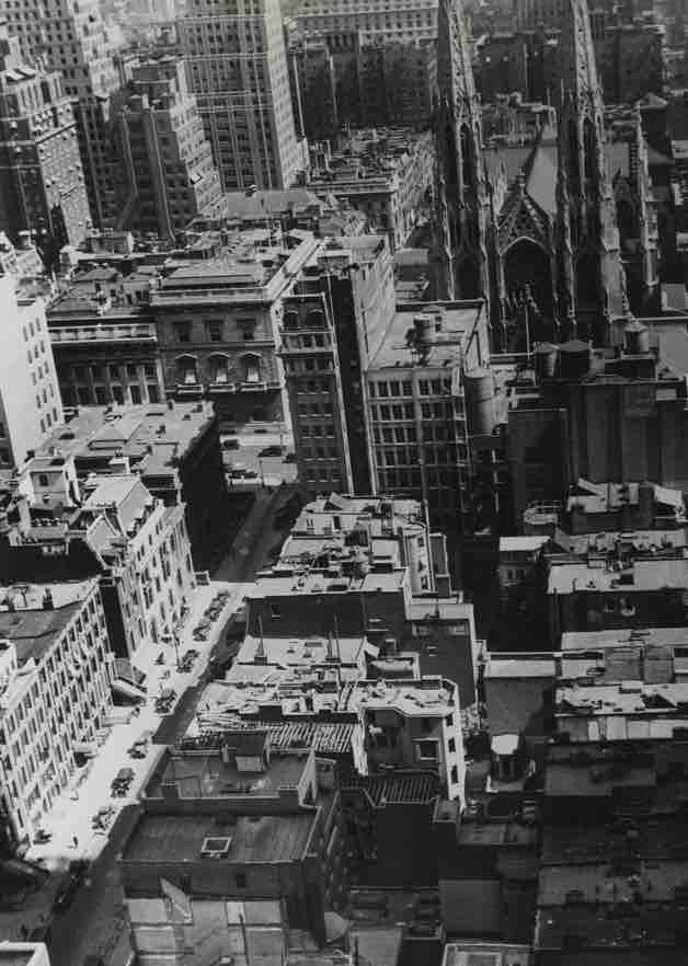 Black-and-white aerial view of Midtown Manhattan in 1929, showing the area that would become Rockefeller Center near St. Patrick’s Cathedral.