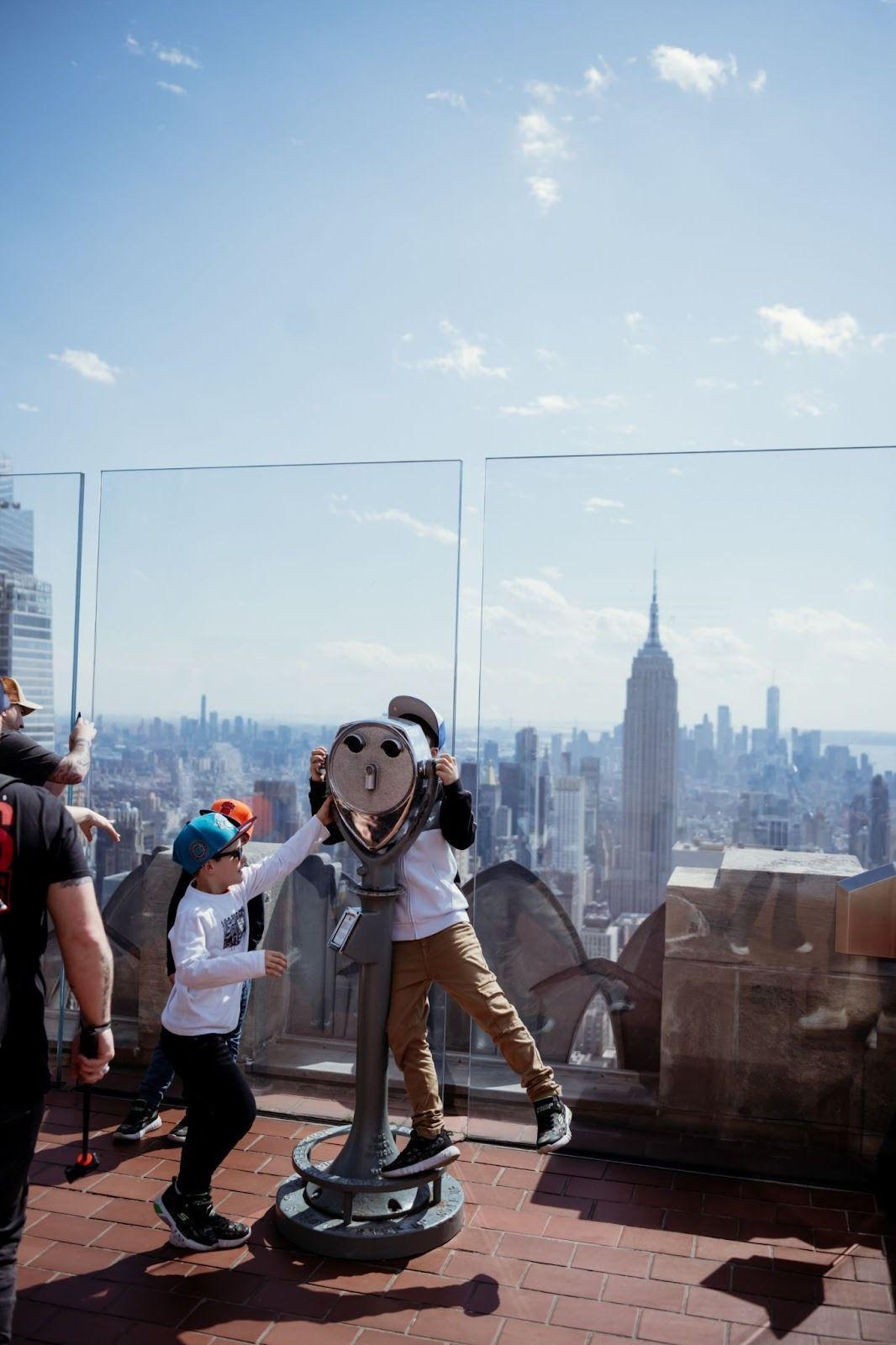 two kids standing at Top of the Rock observatory deck