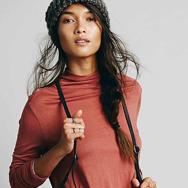 Free People model wearing a backpack and beanie