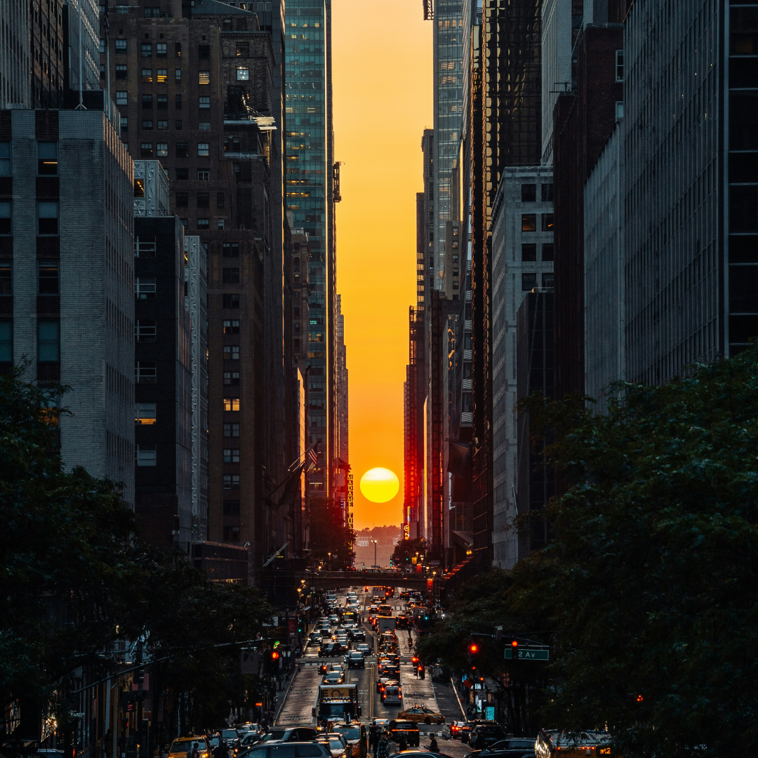 The sun peeking through buildings during Manhattanhenge