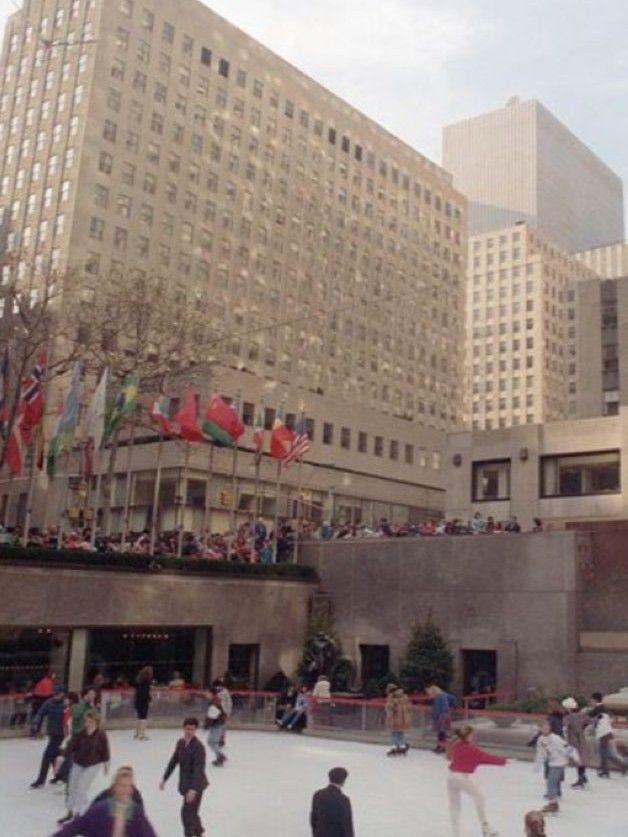 Color photo of skaters at Rockefeller Center rink in 1988, with flags and surrounding buildings visible above the plaza.