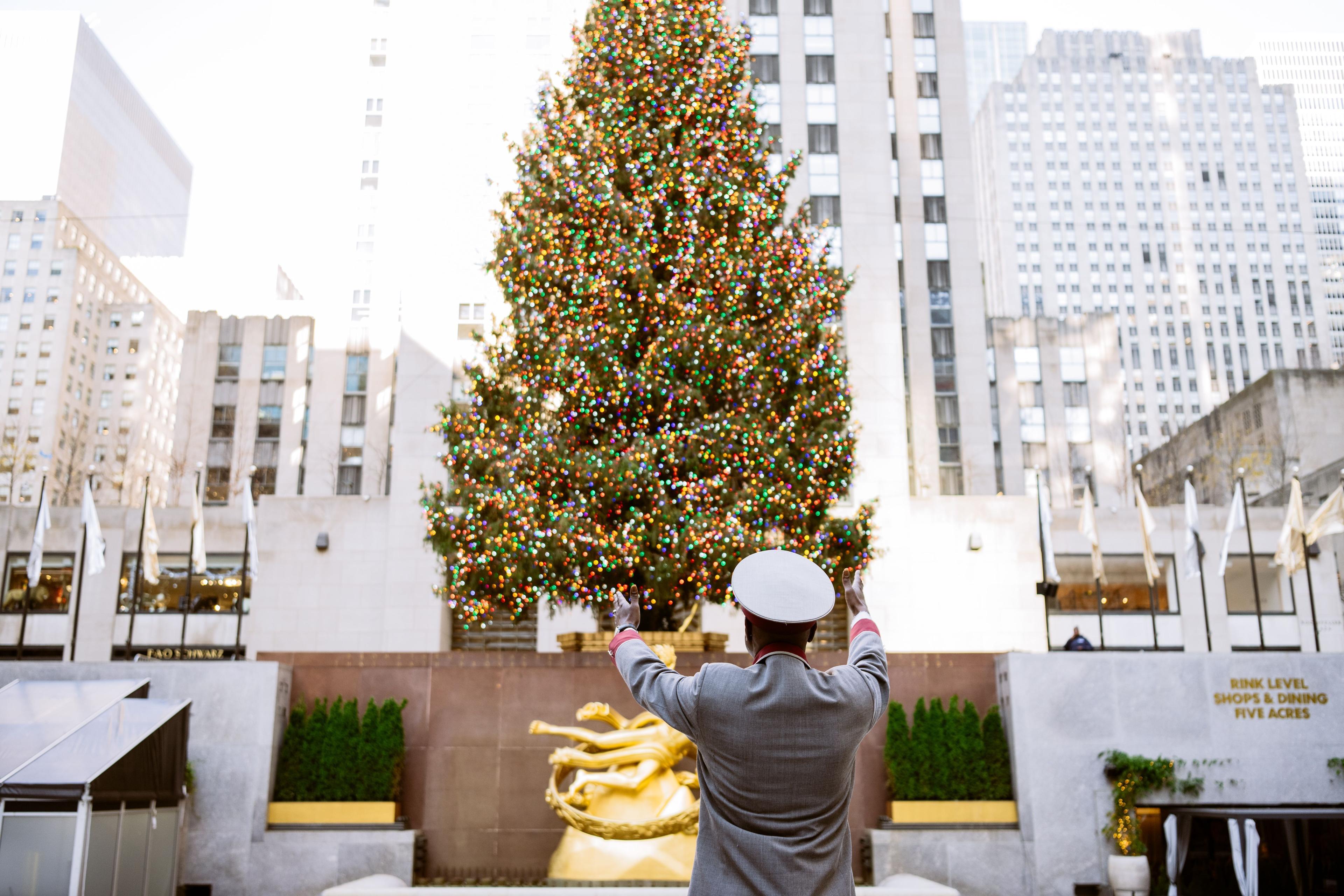 the mayor of rock center pointing to the Rock Center tree