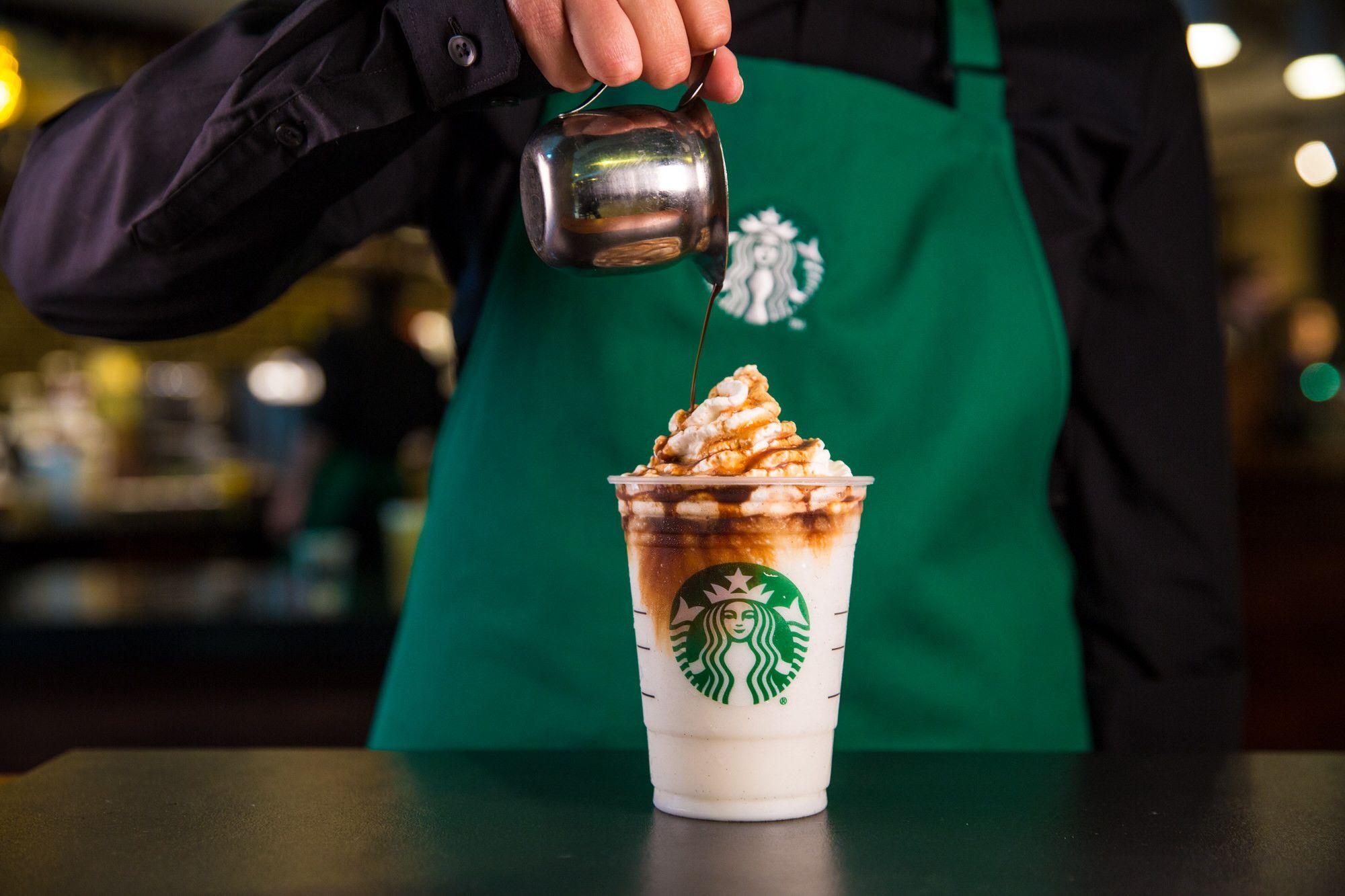 worker pouring coffee into cup