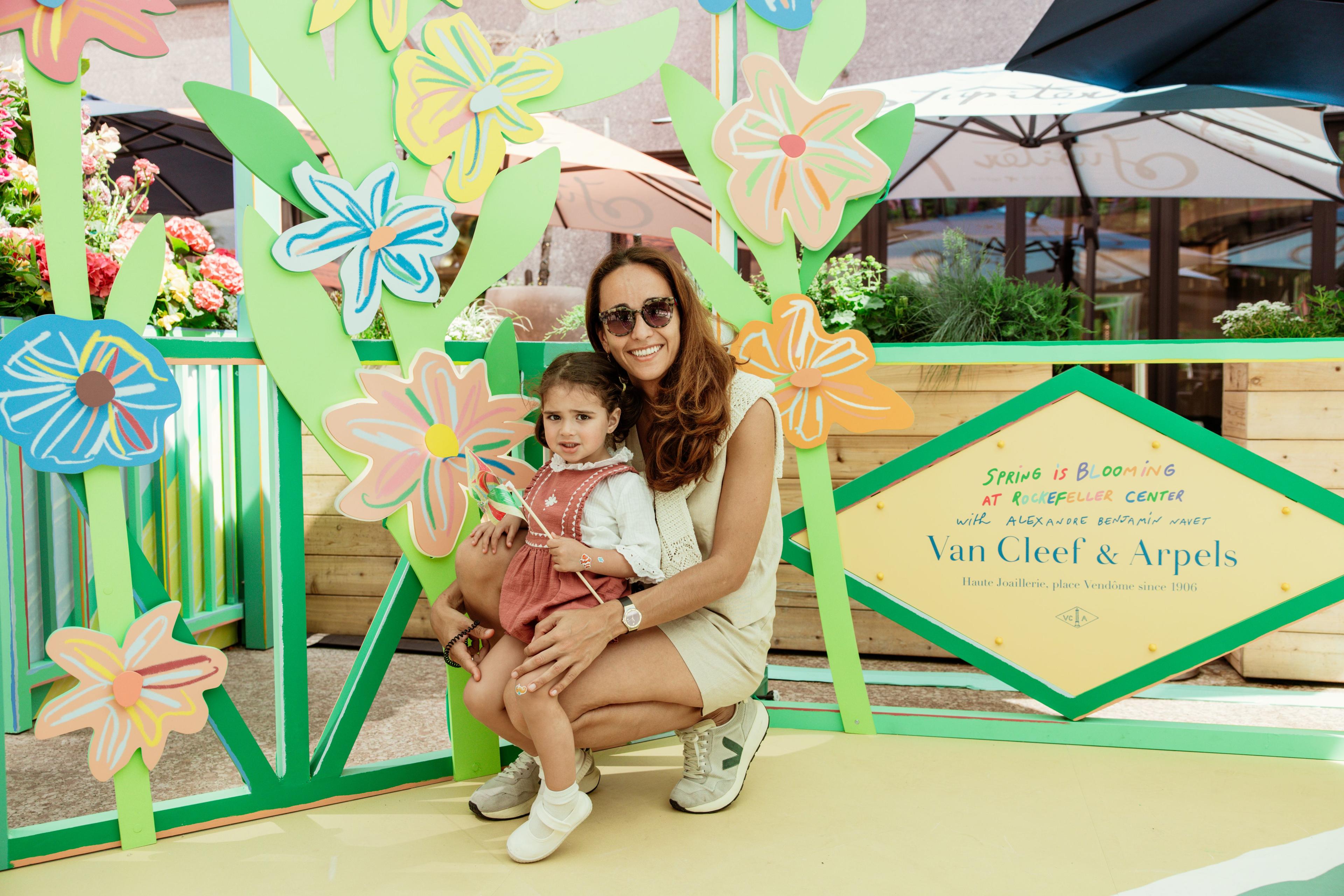 mother and daughter smiling at rockefeller center