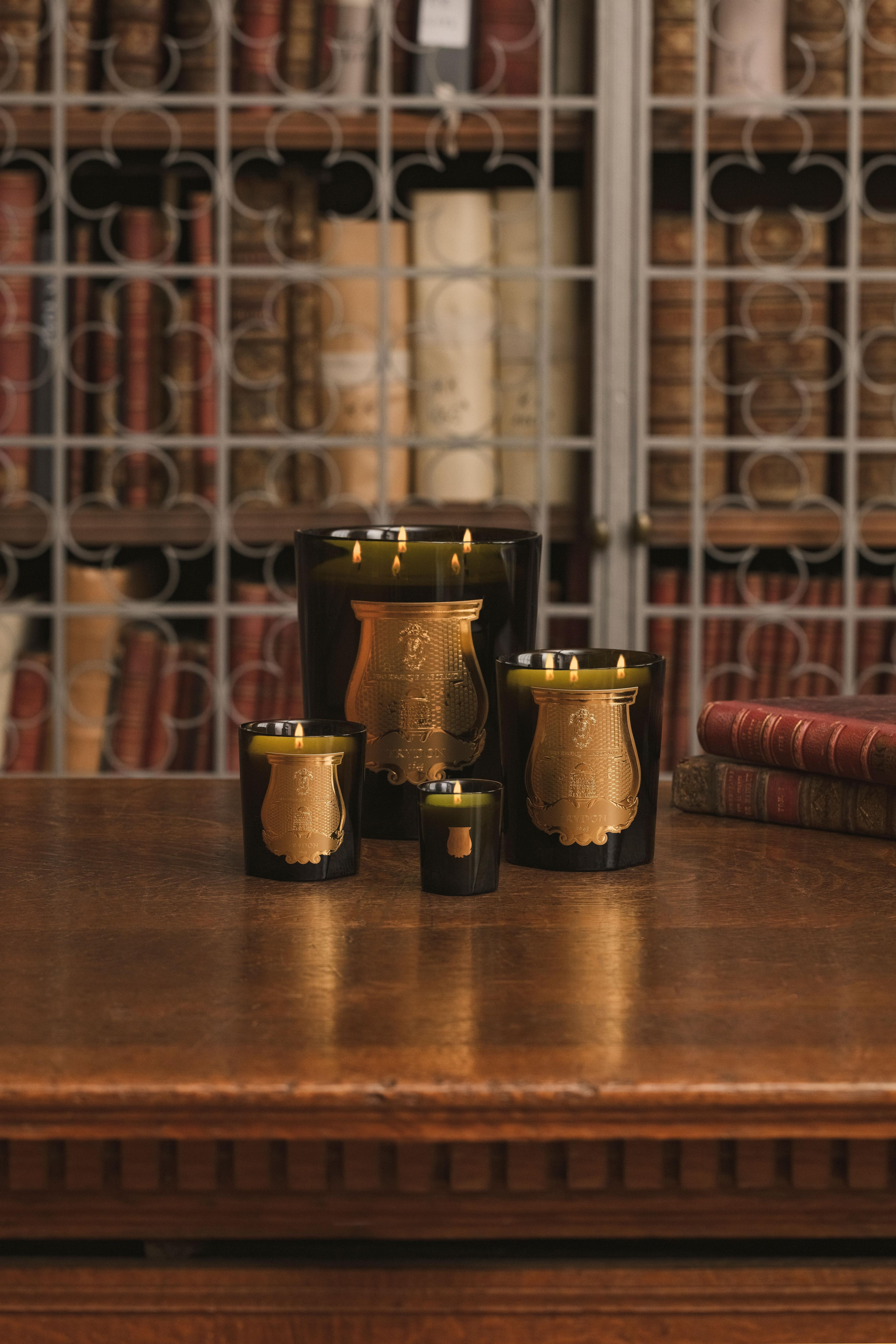 4 candles on a wooden table