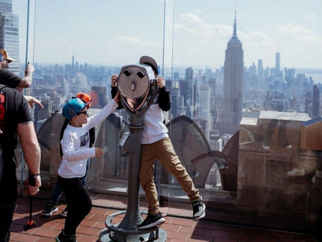 two kids standing at Top of the Rock observatory deck