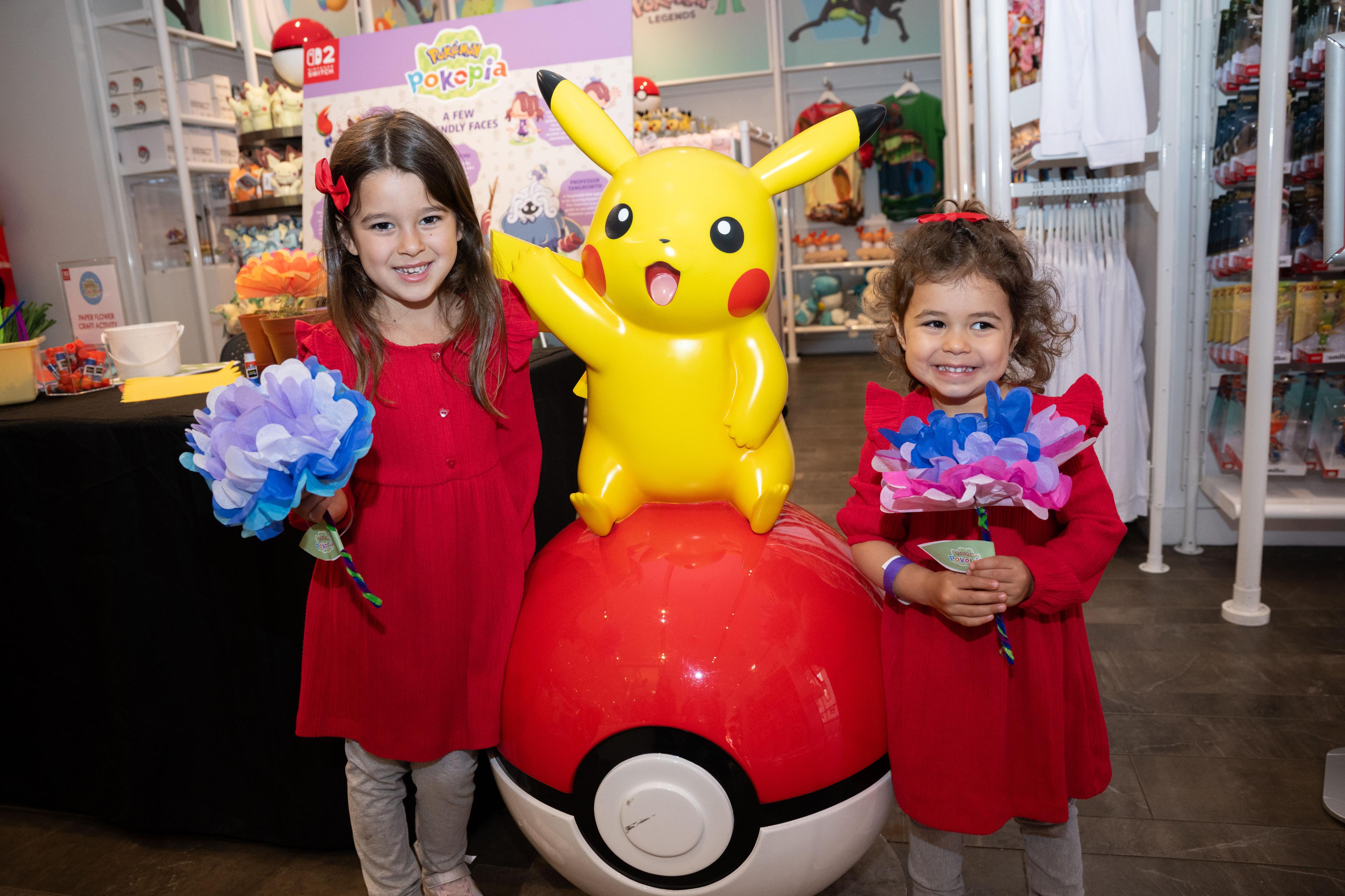 two girls smiling with picachu