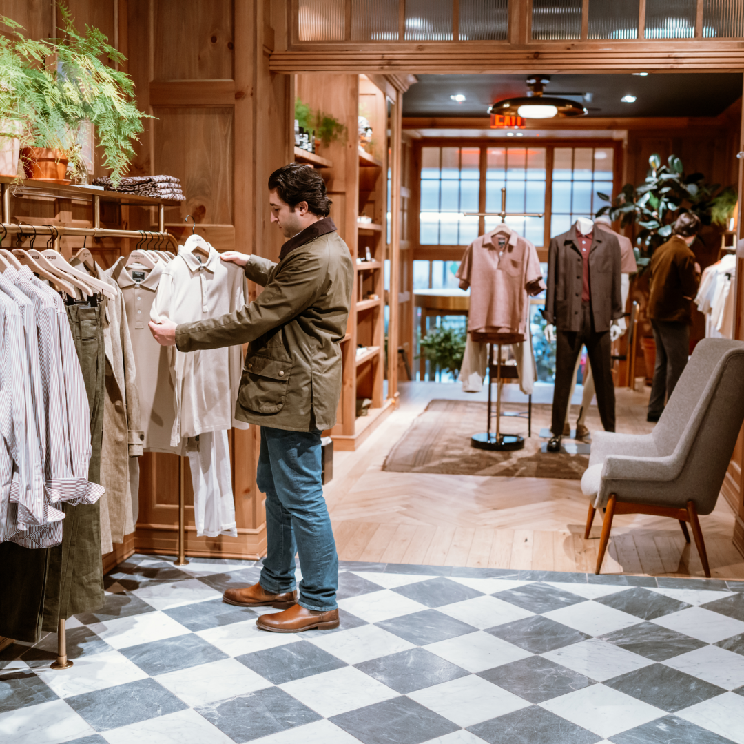 A man browsing a clothing rack at Todd Snyder