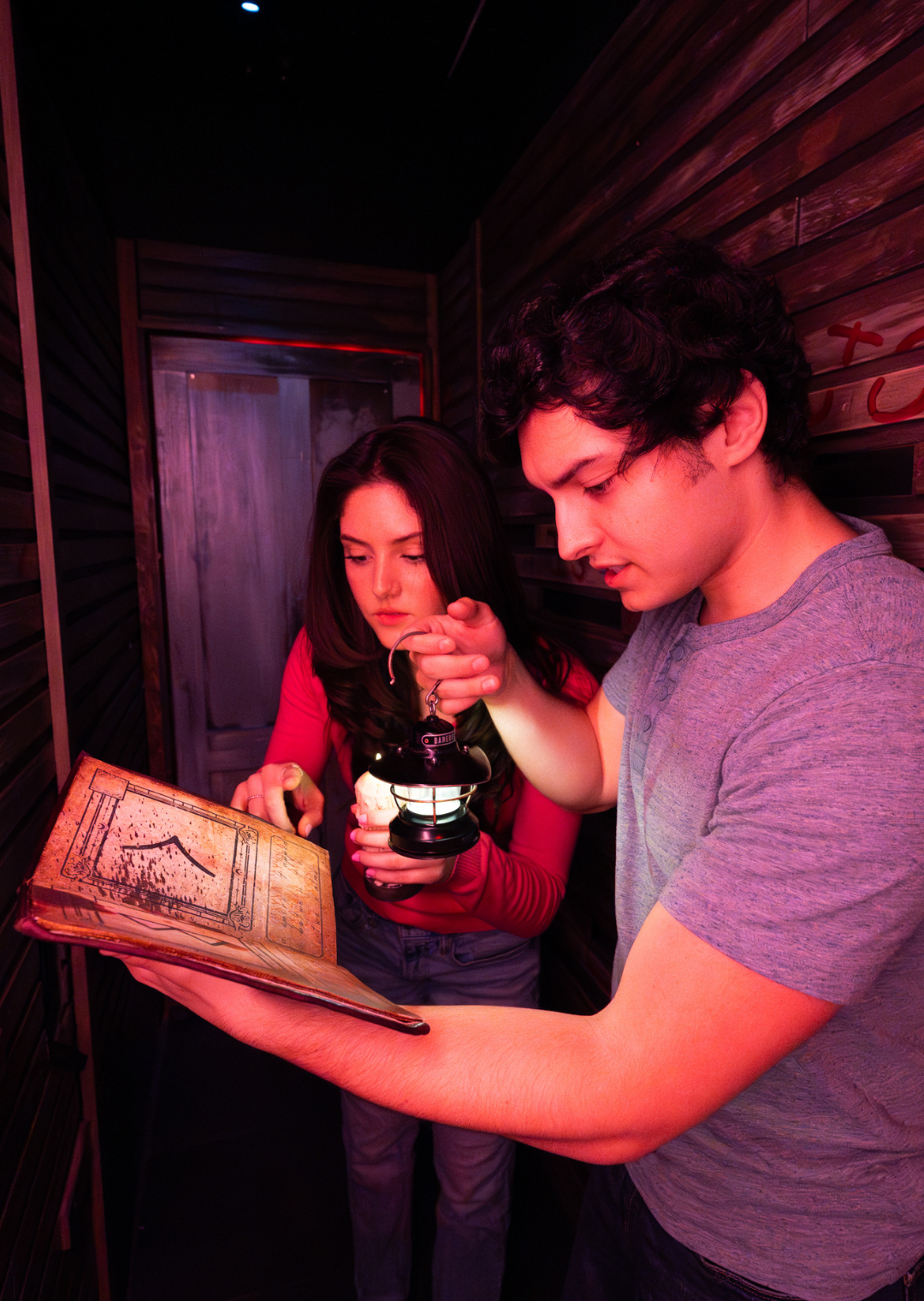 a girl and a boy looking at a book