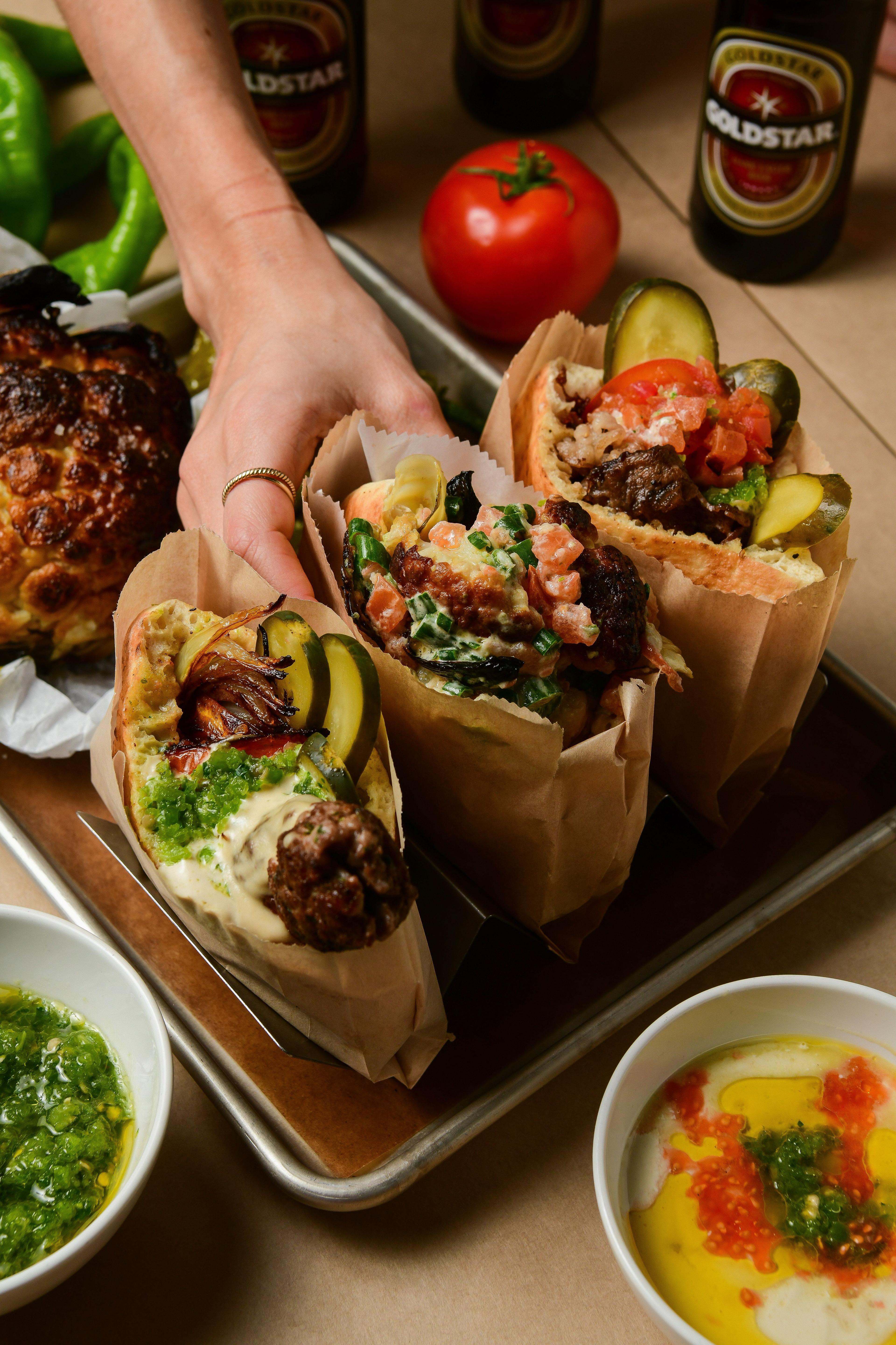 someone grabbing a pita sandwich