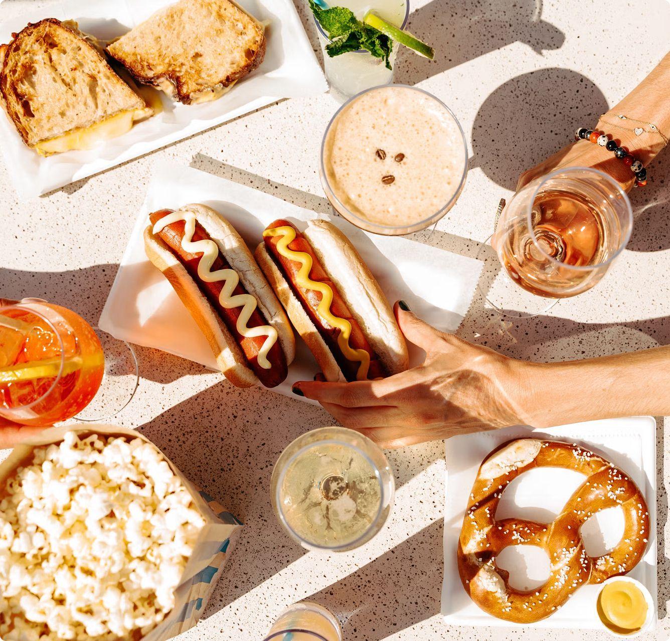 hot dog, popcorn, pretzels, and drinks