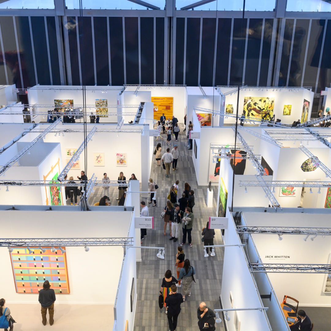 Aerial view of people looking at art in various booths at Frieze New York