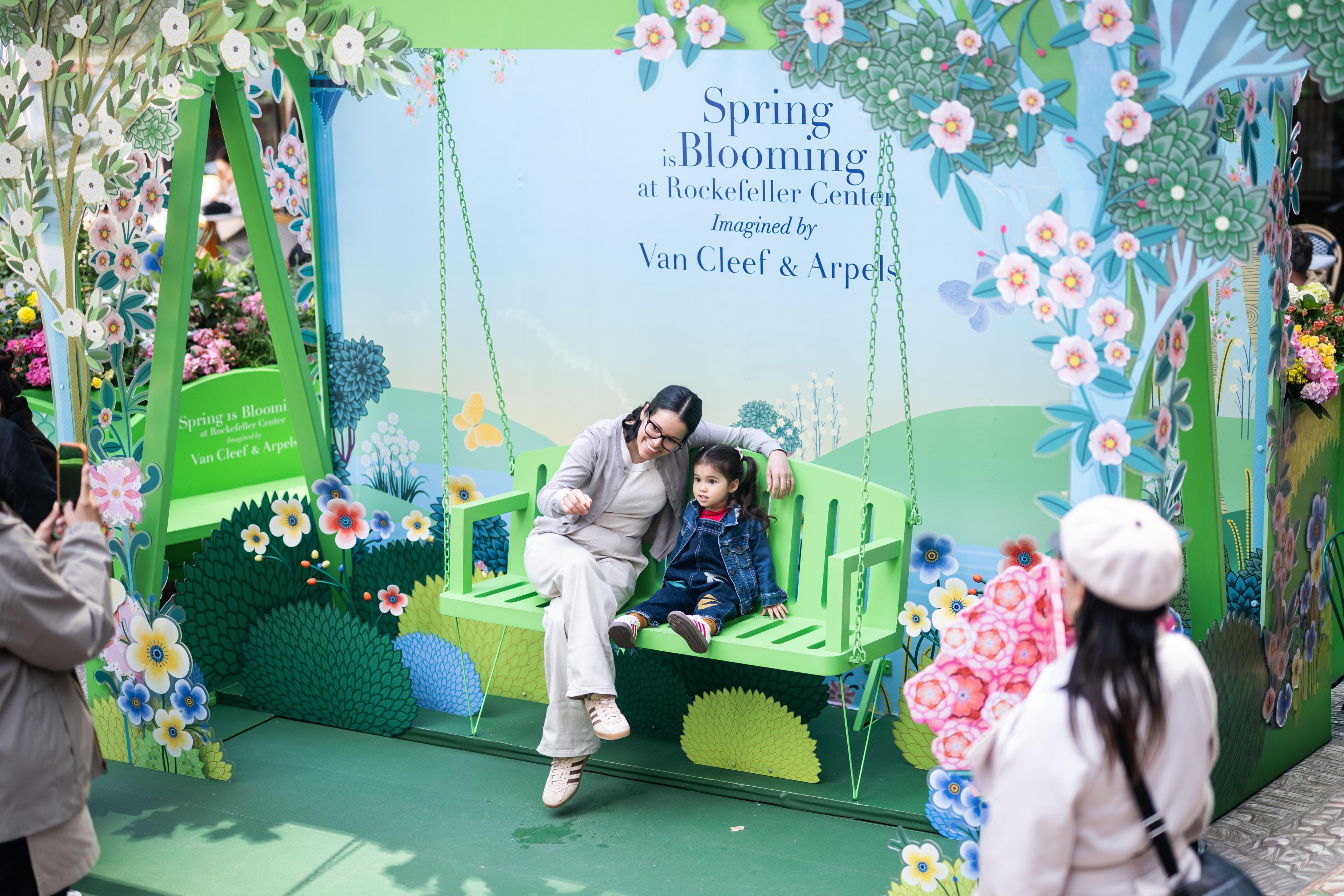 a mother and child smiling at spring is blooming installation