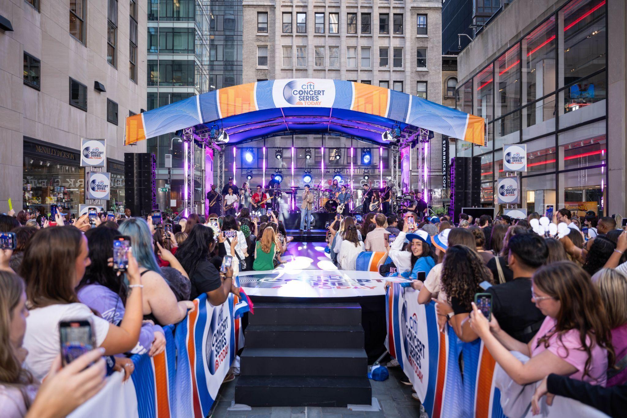 people watching a show on the rockefeller center stage
