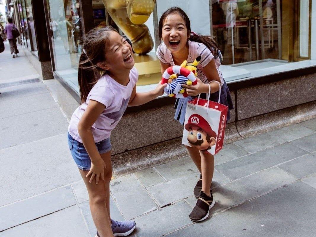 two girls smiling at rockefeller center
