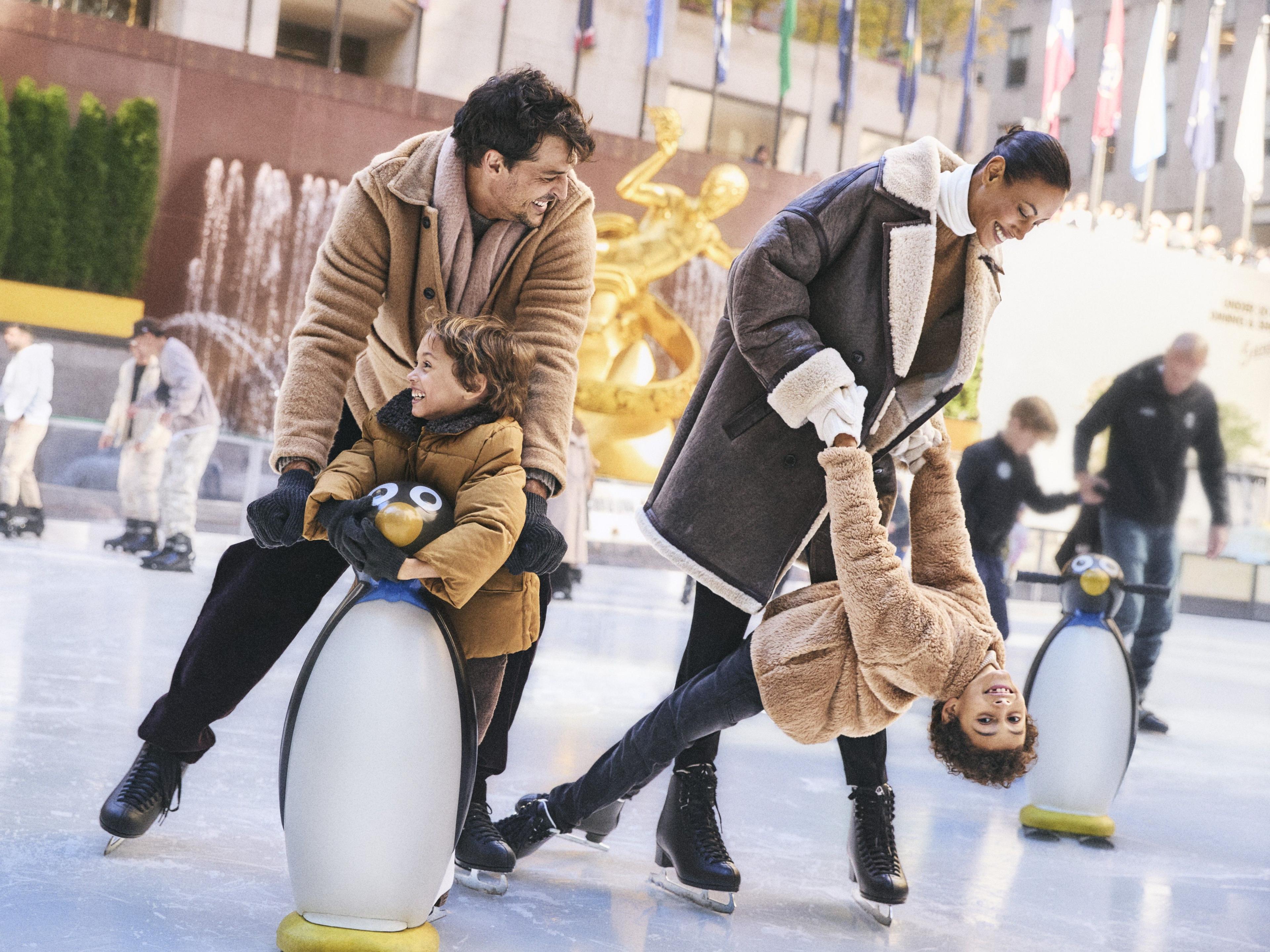 family ice skating at Rockefeller Center
