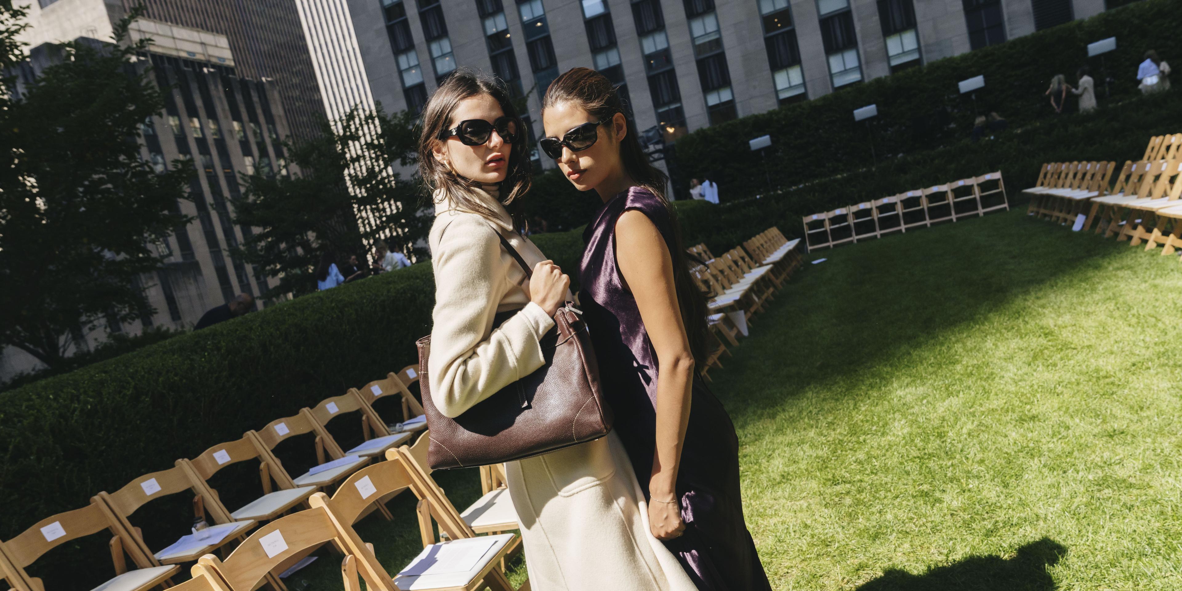 two women posing at fashion show