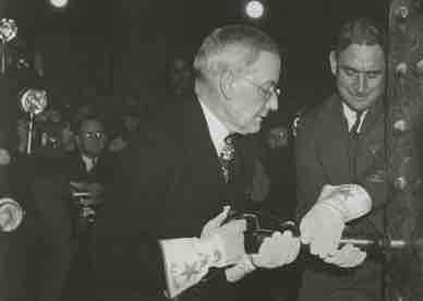 John D Rockefeller installs the final rivet at the Rockefeller Center closing ceremony