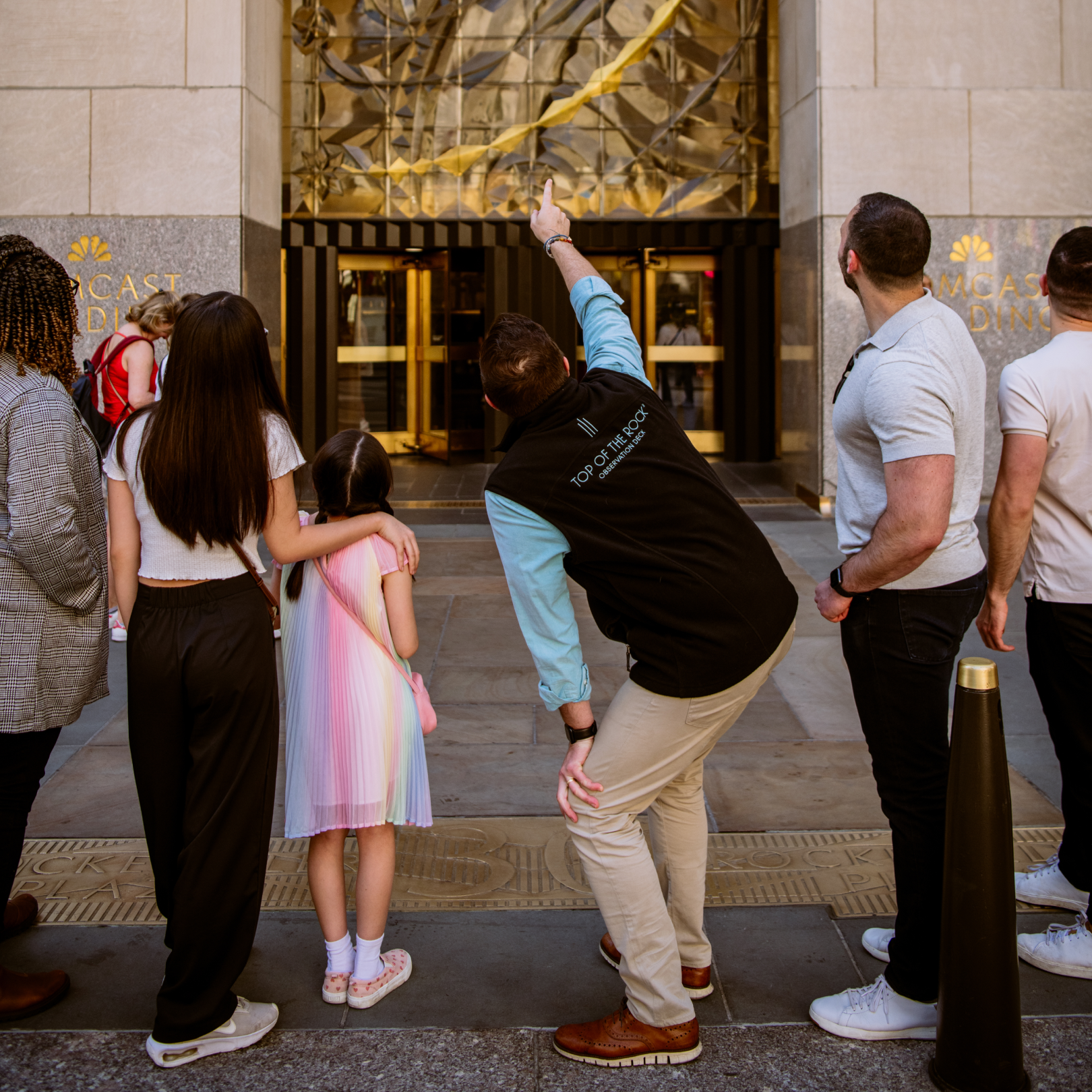 A family looking at a building during the Rockefeller Center Tour, Jr.